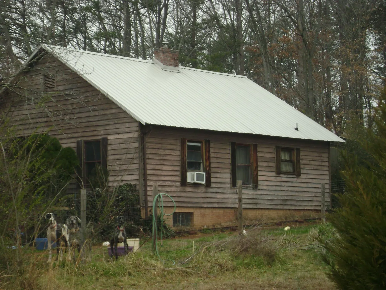 White metal roof on an old wood sided farmhouse, from a Asphalt Shingle Roof Repair job in Hixson